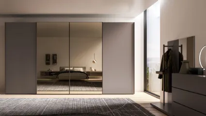 Sliding wardrobe with internal Cotton structure, doors in matte Clay lacquer and bronzed mirror.