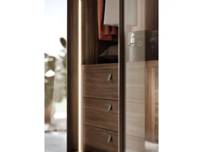 Sliding wardrobe with Frame door. Internal in terracotta, Frame doors in bronzed glass and burnished metal.