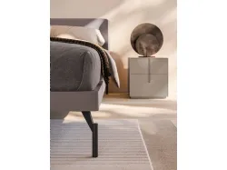Double bedroom with Aura bed, matte lacquered bed frame and burnished metal feet.