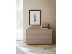 Aura double bed with matte lacquered bedframe and burnished metal feet.