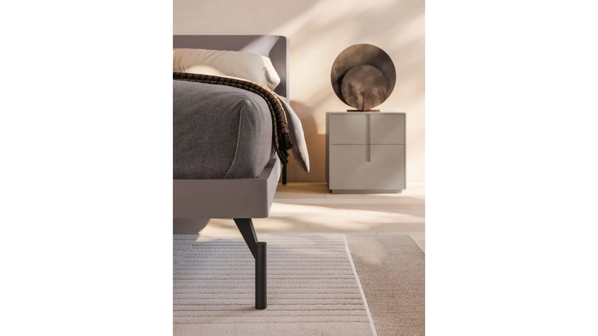Double bedroom with Aura bed, matte lacquered bed frame and burnished metal feet.