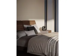 Double room complete with a bed with a textured bed frame and a dark metal foot.