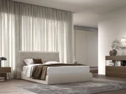 Double bedroom with bed frame with fabric bedskirt and night group in textured terracotta.
