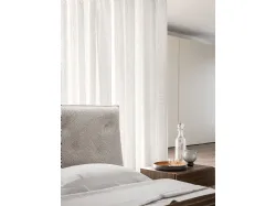 Double bedroom with Bed Fiocco with fabric bed frame and night group in cotto material.