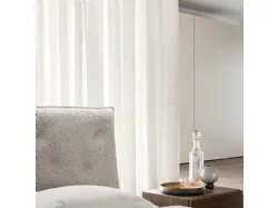 Double bedroom with bed Fiocco with fabric bed frame and night group in textured Cotto.