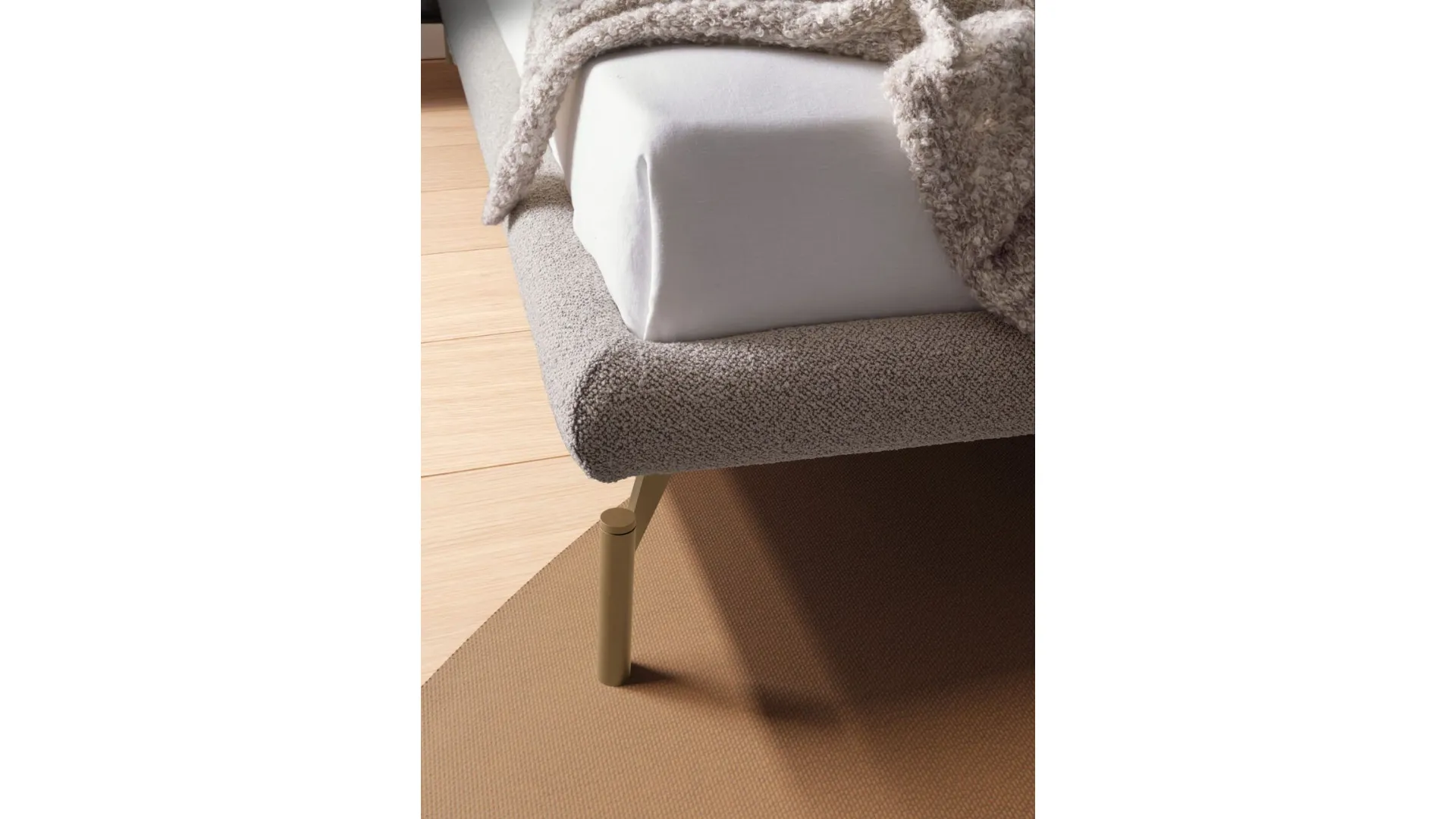 Double bed model Alissa with upholstered bed frame and Palladio lacquered metal foot.