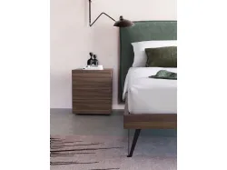 Double bed model Alissa upholstered in fabric with textured bed frame and metal feet.