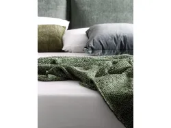 Double bed model Alissa upholstered in fabric with textured bed frame and metal feet.