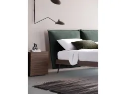 Matrimonial bed model Alissa upholstered in fabric with textured bed frame and metal feet.