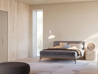 Double bed model aura with lacquered matte Clay bedframe and burnished metal feet.