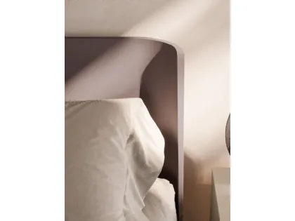 Double bed model aura with bed frame in matte lacquered Clay and feet in burnished metal.