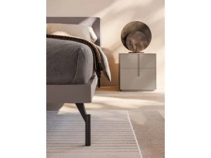 Double bed model aura with bed frame in matte lacquered Clay and feet in burnished metal.