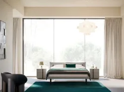 Double bed model Brigitta with upholstered bed frame and Carbon texture foot.