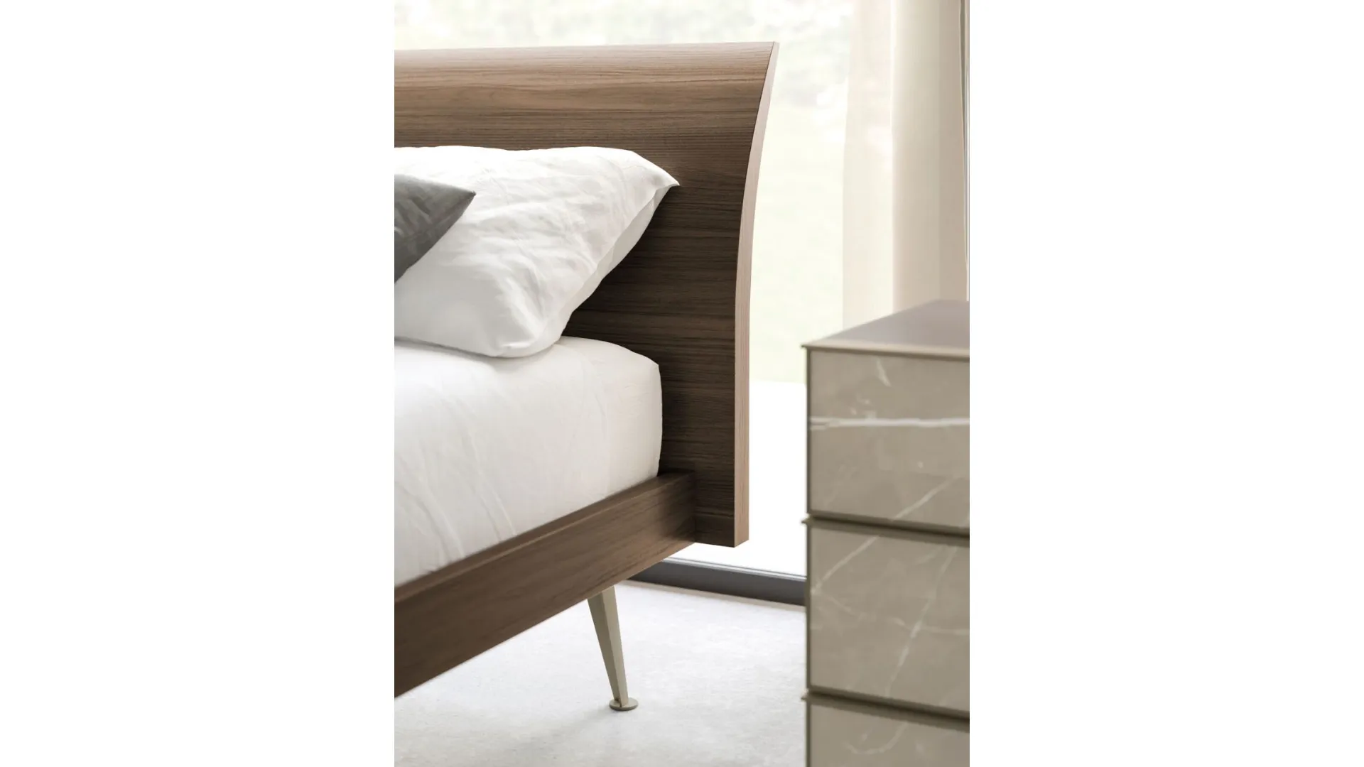 Double bed Loge model with material headboard and Palladio lacquered metal base.