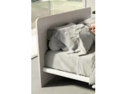 Double bed with rounded headboard, high-quality materials, and customizable finishes.