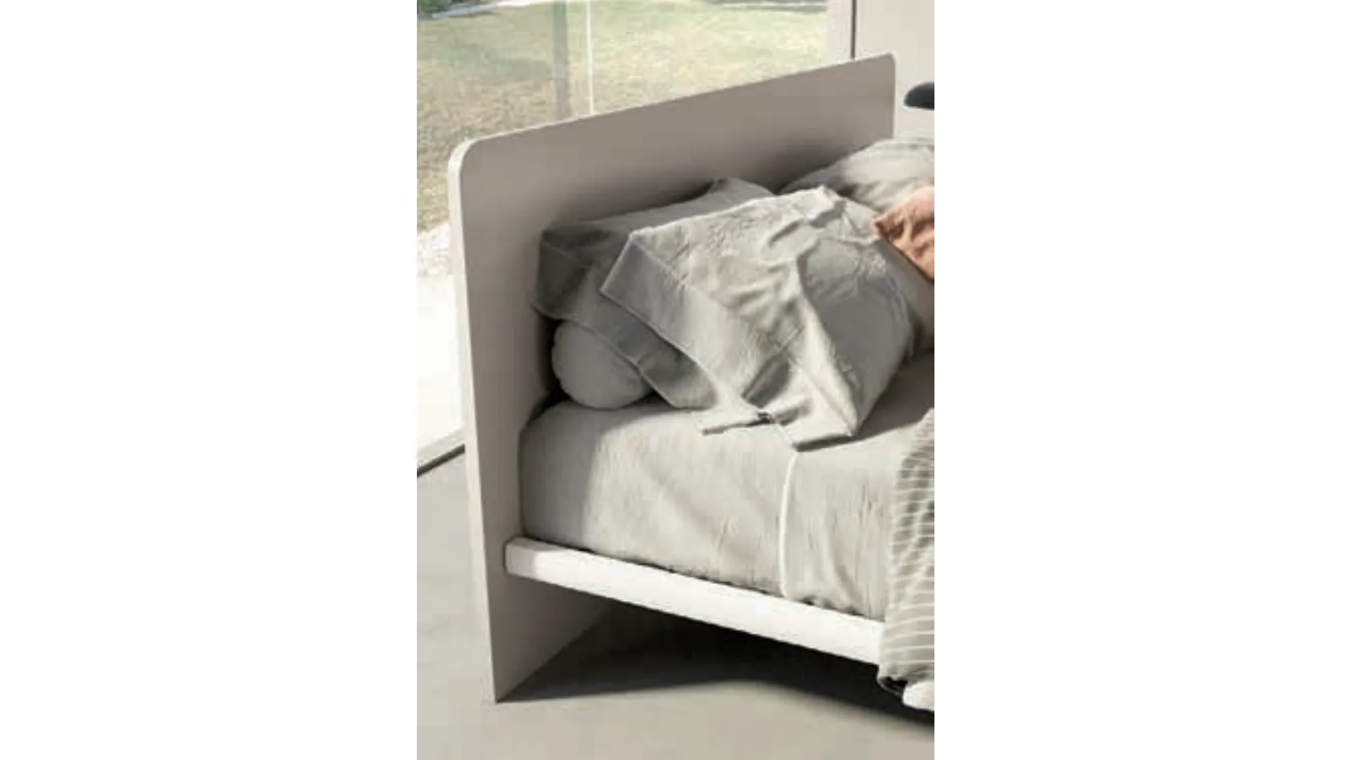 Double bed with rounded headboard, high-quality materials, and customizable finishes.