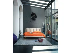 Modern double bed with original headboard with six cushions.