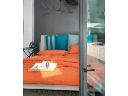 Modern double bed with original headboard with six cushions.