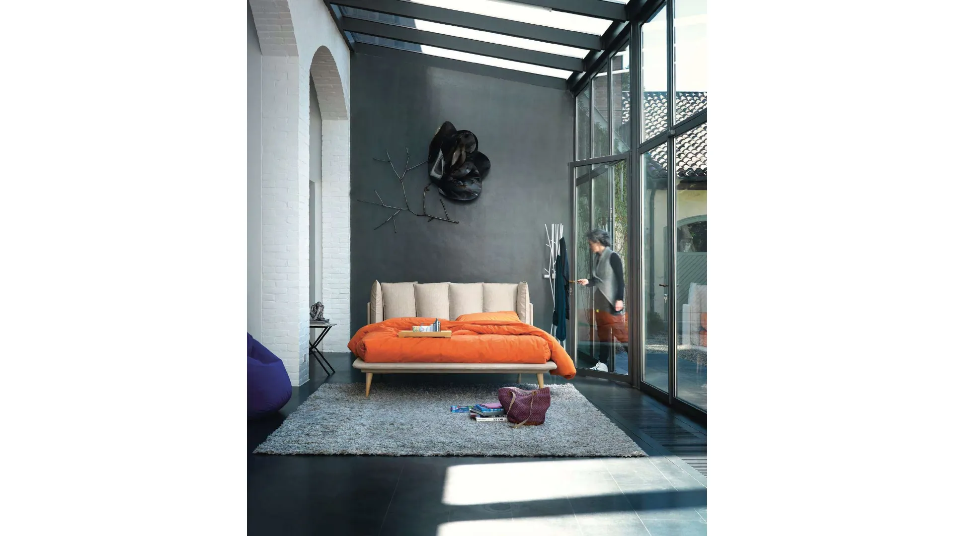 Modern double bed with original headboard with six cushions.