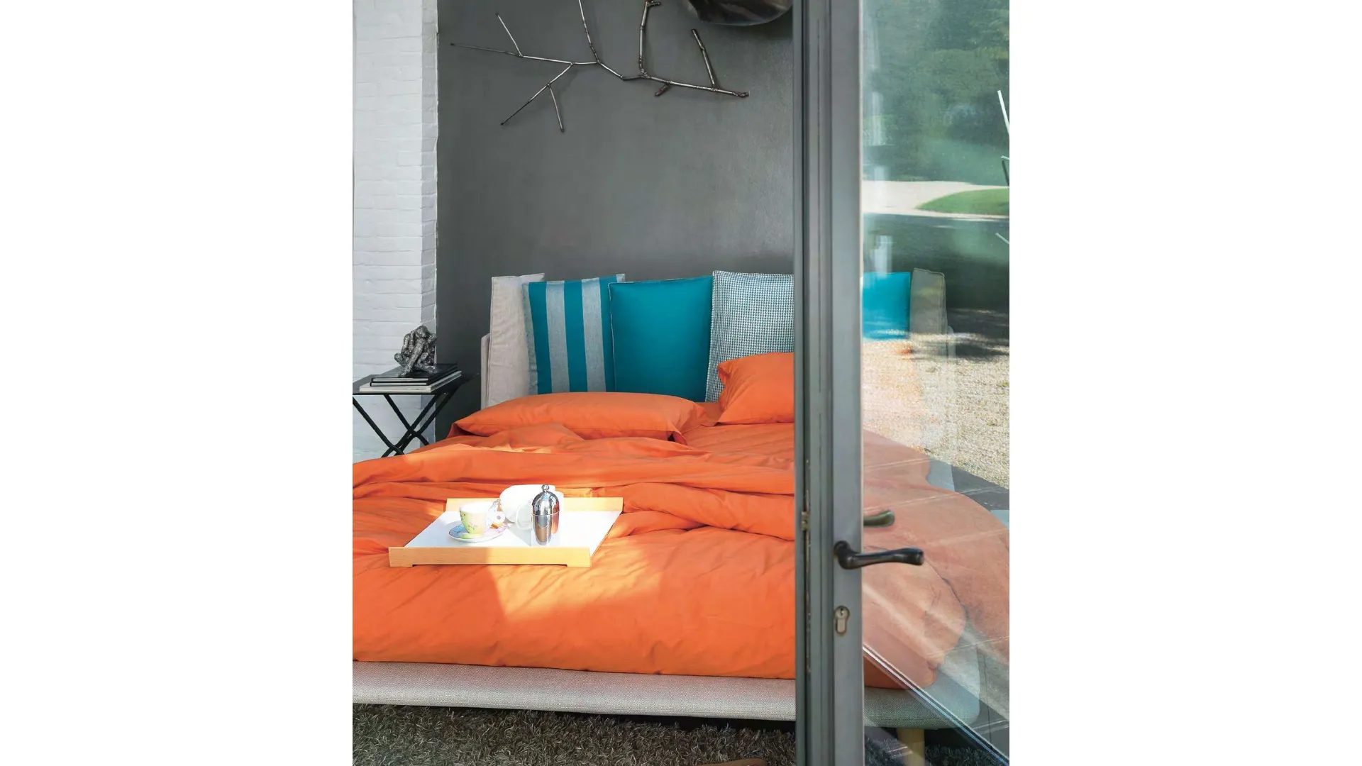 Modern double bed with original headboard with six cushions.