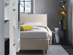 Double bed with padded headboard, customized finishes.