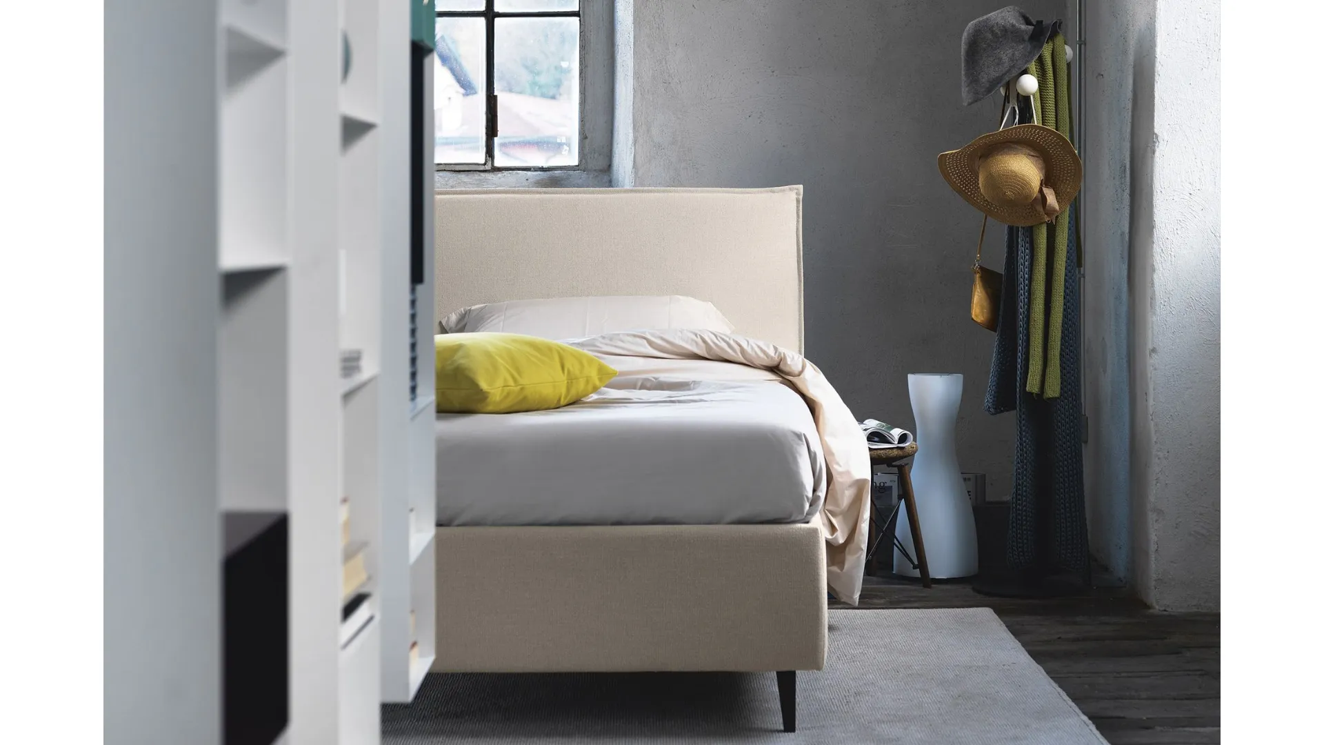 Double bed with padded headboard, customized finishes.