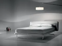 Marital double bed with distinctive metal sled foot.