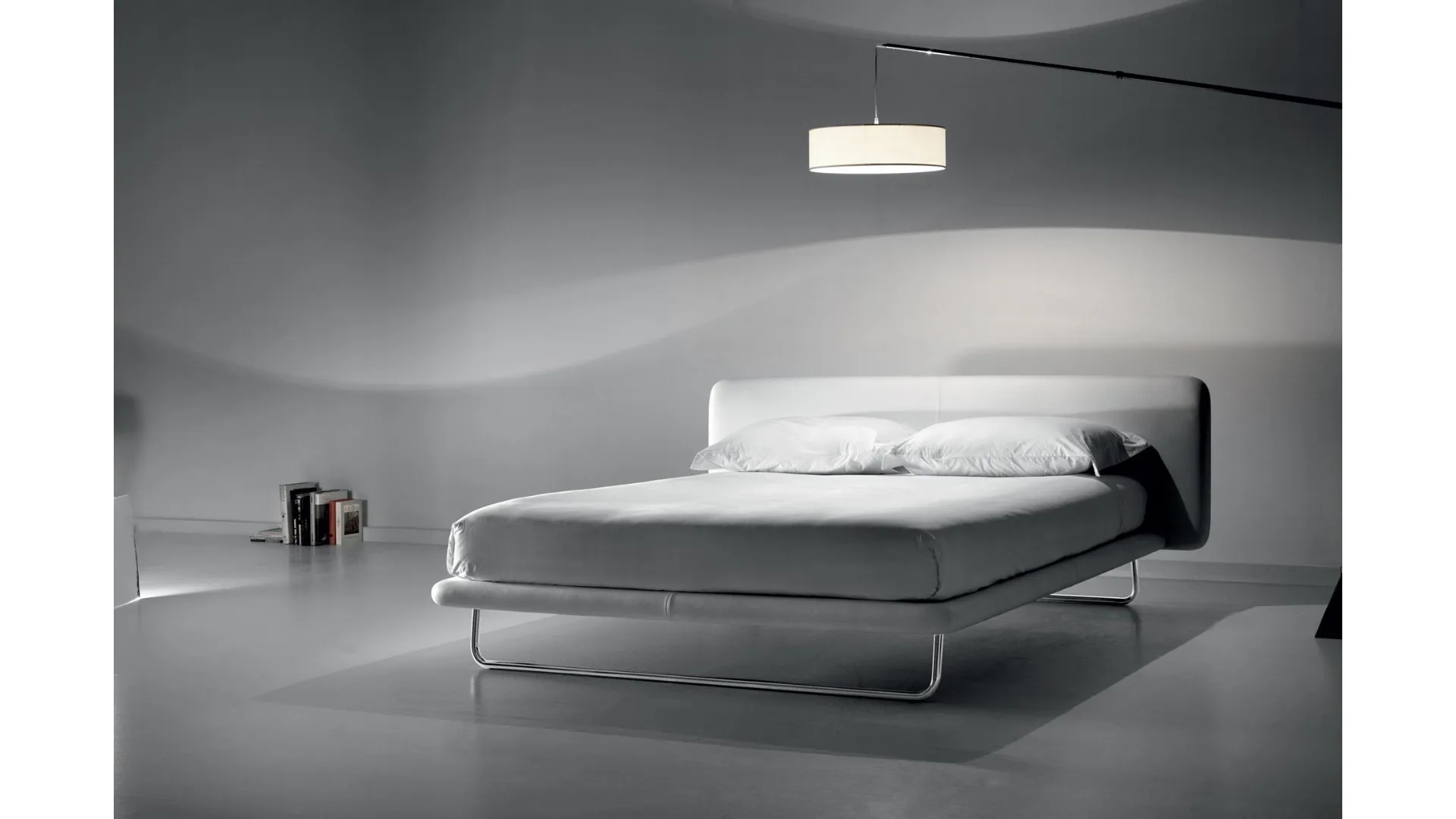 Marital double bed with distinctive metal sled foot.