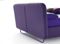 Wide double bed with modern design and storage container.