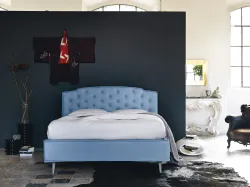 Double bed with storage container and capitonnè processing in frank fabric.