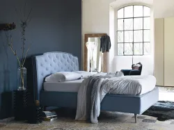 King size bed with container, upholstered in capitonnè style.