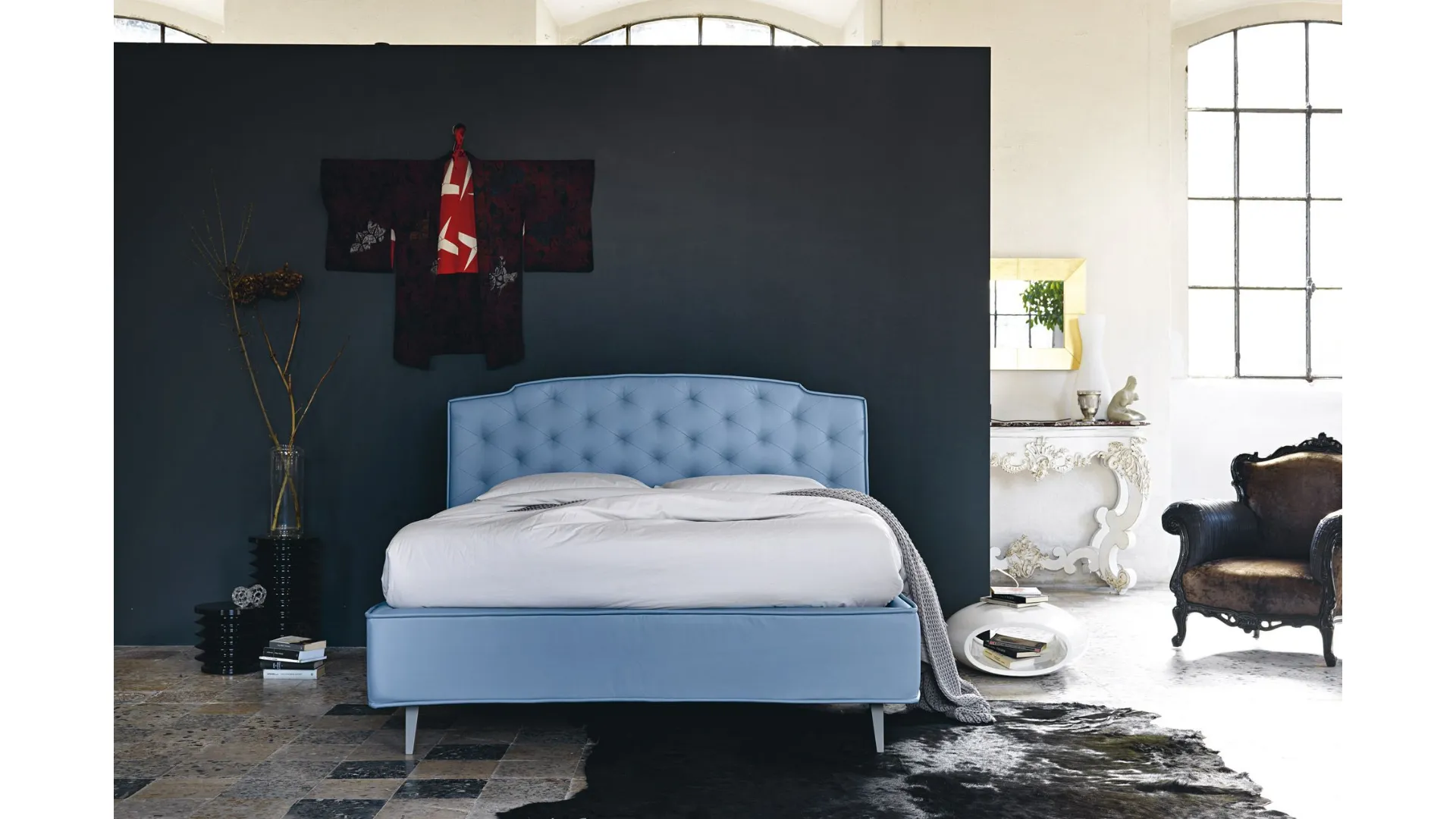 Double bed with storage container and capitonnè processing in frank fabric.