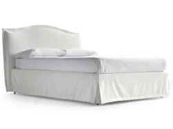 Nightly, double romantic canopy bed with bedskirt covered with a soft valance.
