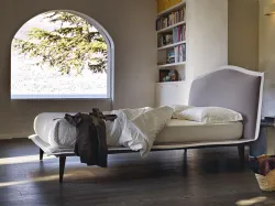 Noctis Lyle Voulant double bed with slightly tilted headboard and wooden legs.