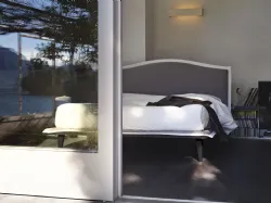 Nightime Lyle double bed with slightly inclined headboard and wooden feet.