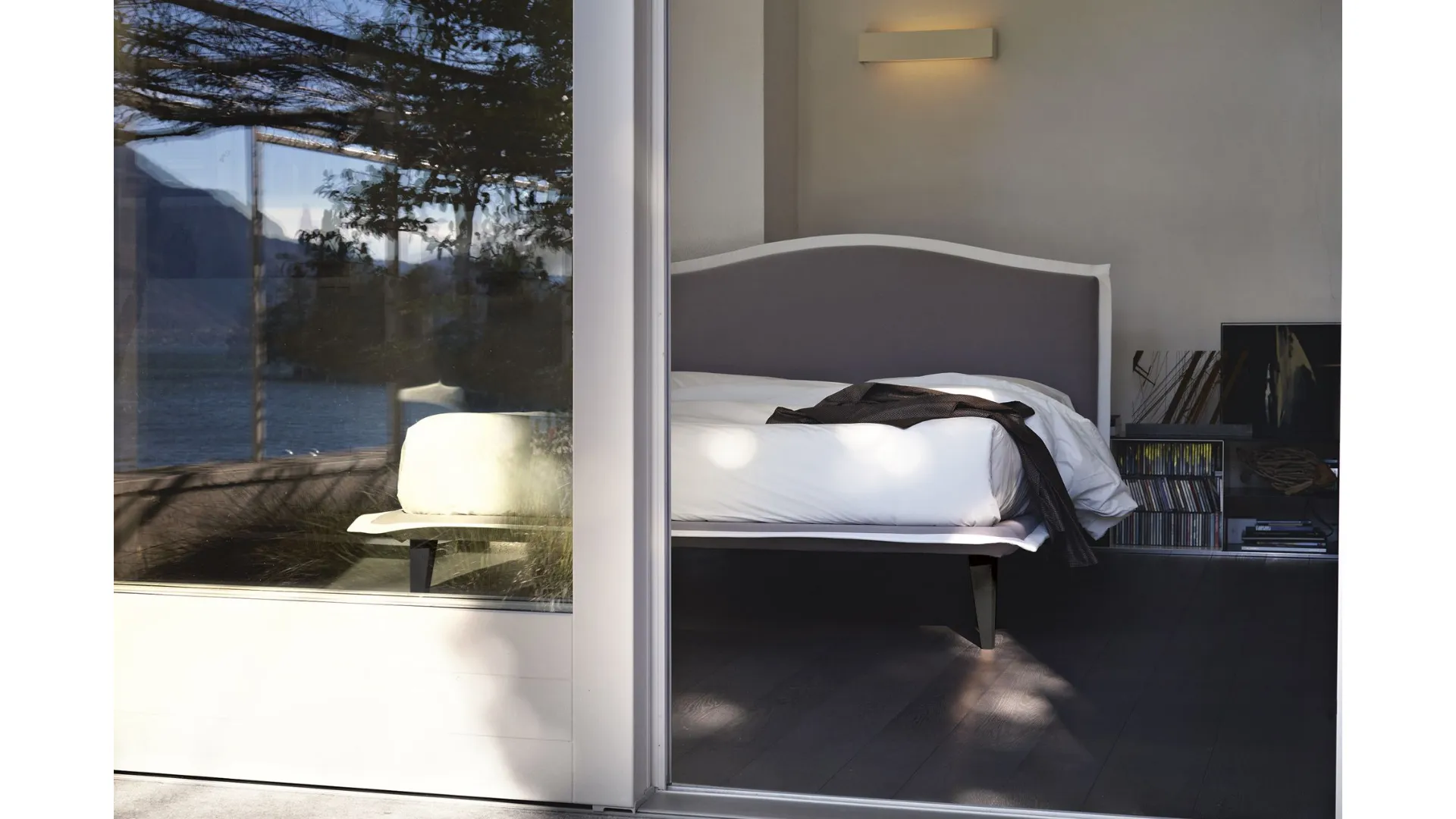 Nightime Lyle double bed with slightly inclined headboard and wooden feet.
