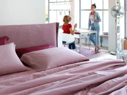 Double bed with a curved and enveloping padded headboard from Noctis Osaka
