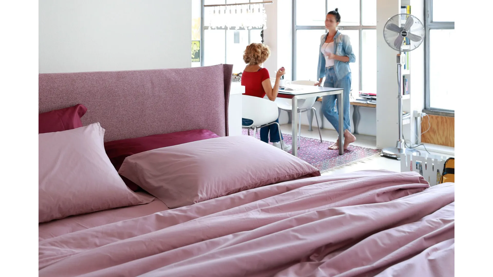 Double bed with a curved and enveloping padded headboard from Noctis Osaka