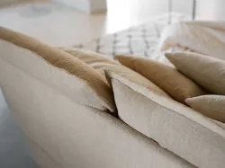 Double bed with two pillows finished with a characteristic ruffle.
