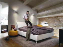 Double regular bed with removable cushions covered in quilted fabric.