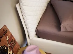 Double bed with regular size pillows with removable and fabric quilted covers.