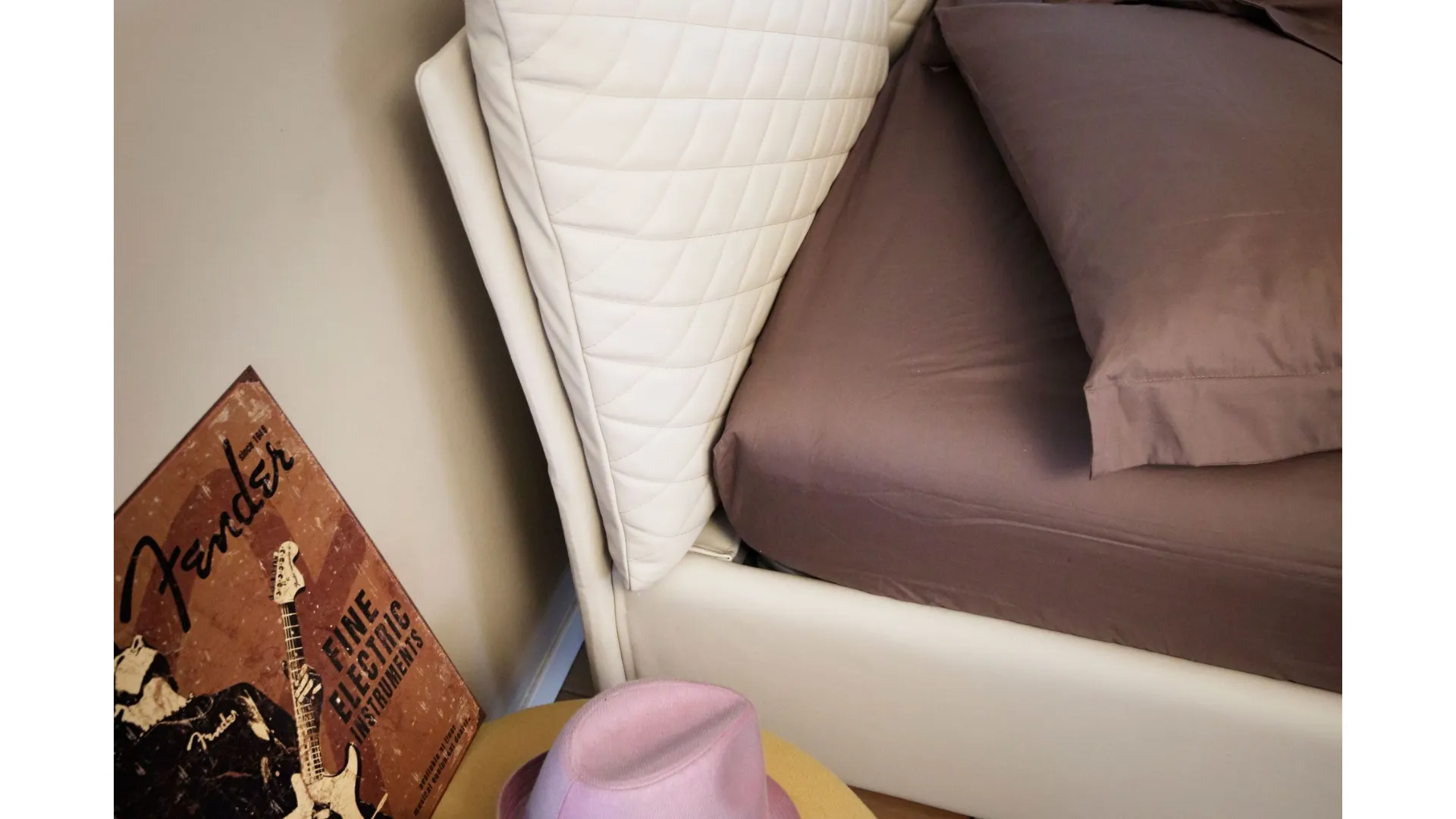 Double bed with regular size pillows with removable and fabric quilted covers.