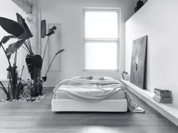 Double bed with modest capacity storage container.