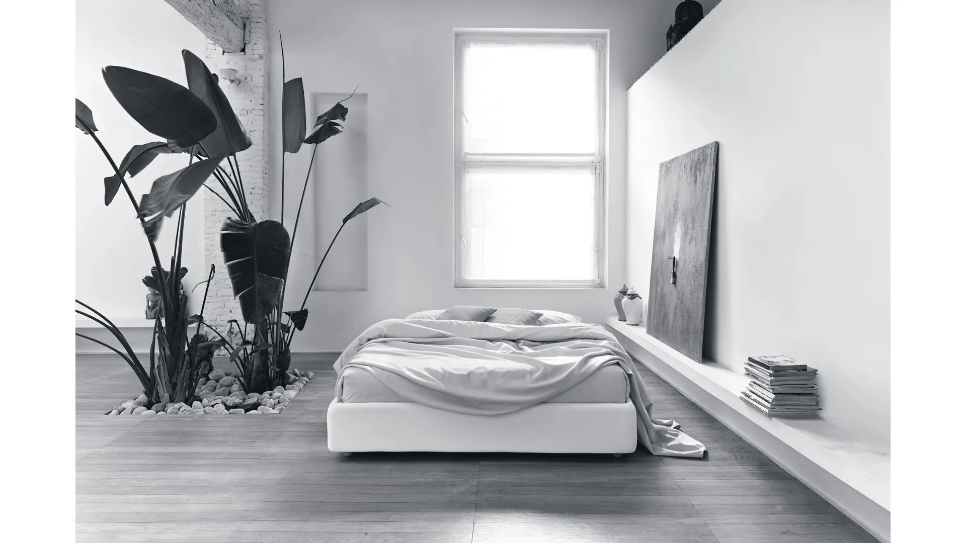 Double bed with modest capacity storage container.
