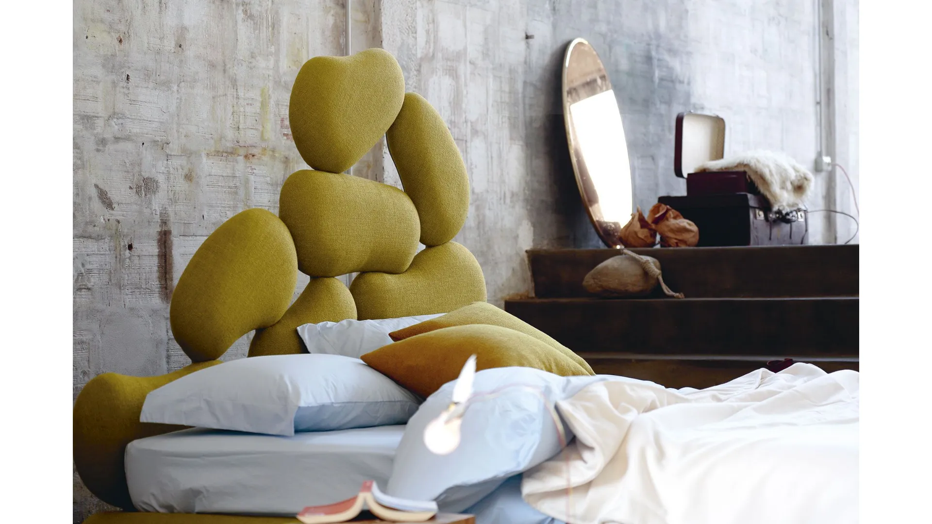 Double bed with wooden headboard cut with a pantograph and upholstered with soft rubber.