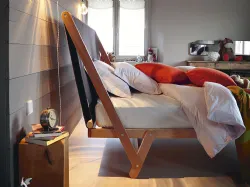 High double bed with high fabric headboard.