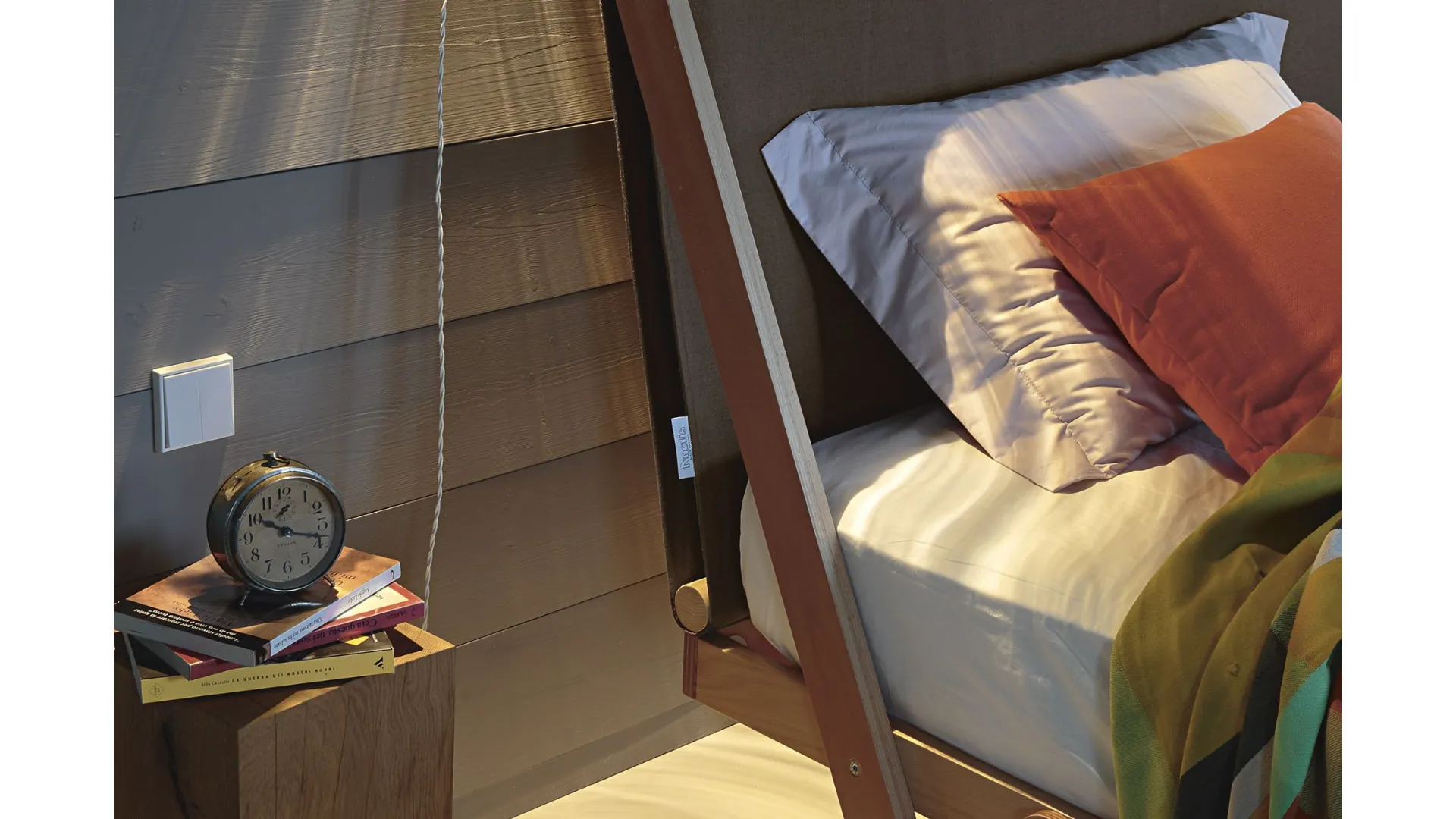 King-size bed with high headboard in fabric.