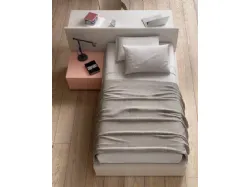 Modern teenager room with a desk that doubles as a headboard to optimize space.