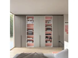 Modern teen room with a desk serving as a headboard to optimize space