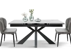 Extendable table with top in white statuary finish and base in anthracite-colored metal.